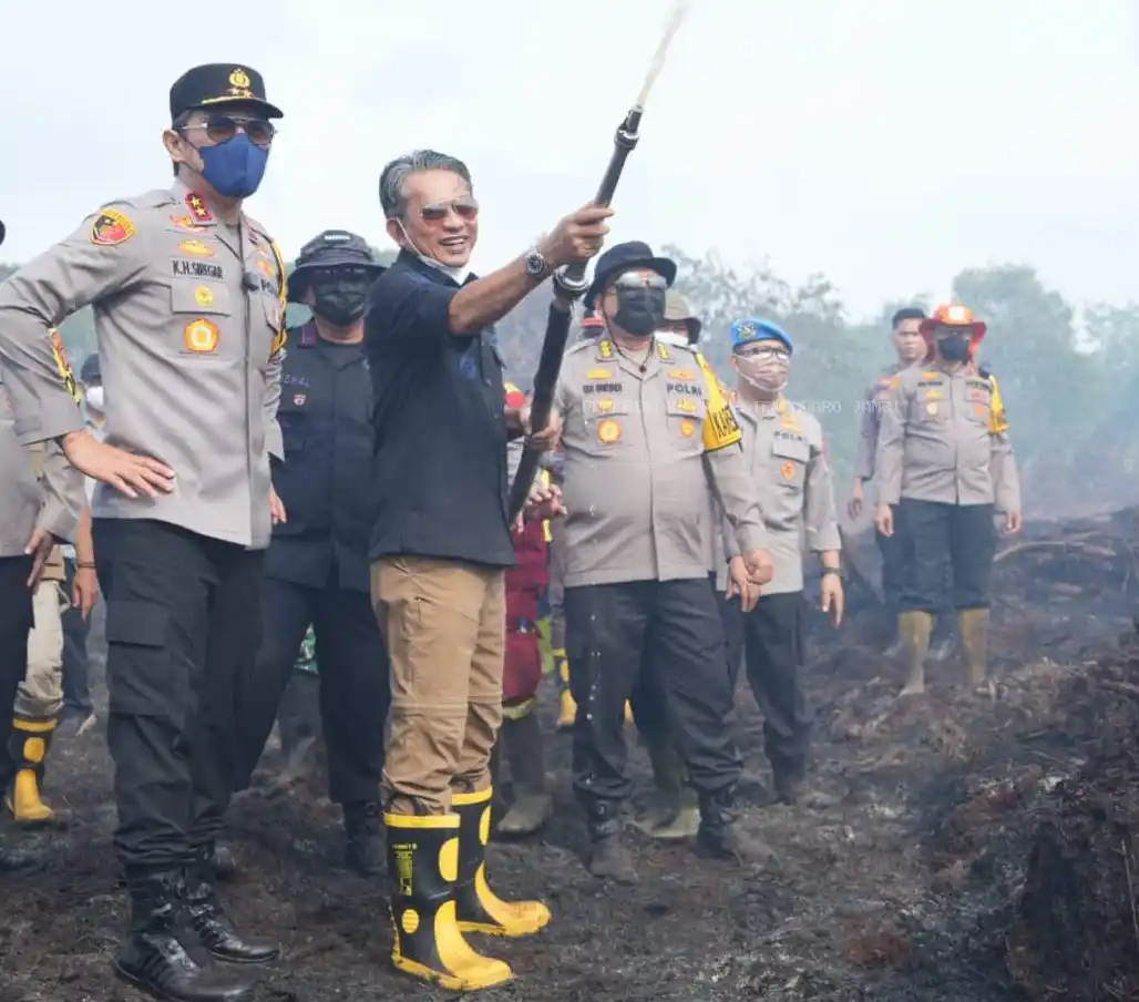Kapolda Jambi, Irjen Pol Krisno H Harahap (kiri) dan Wakil Bupati Muarojambi, H Junadi H Mahir dua dari kiri) ketika membantu pemadaman kebakaran lahan gambut di Desa Gambutjaya, Kecamatan Sungaigelam, Kabupaten Muarojambi, Provinsi Jambi, baru-baru ini. (Foto : Ist)